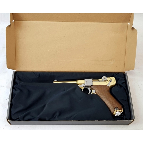 114 - A golden LUGER semi-automatic gas powered pistol. This is an exact replica of the real thing, firing... 