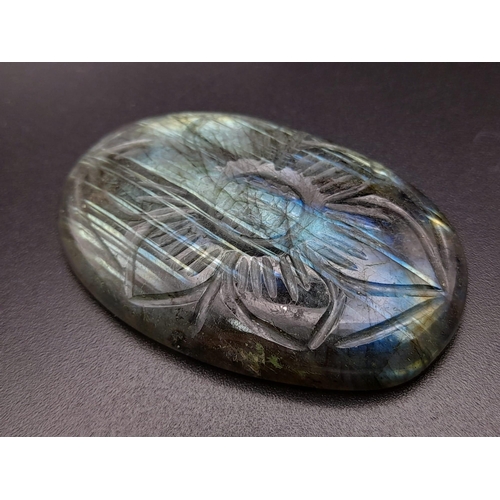 411 - An oval carved labradorite (113.95 carats) with GLA certificate. Dimensions: 49.70 x 32.86 x 8.28 mm... 