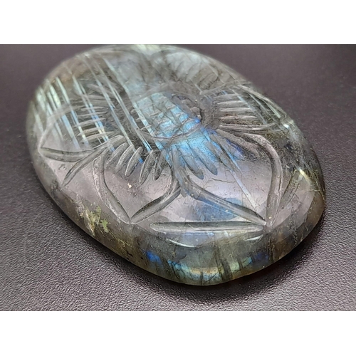 411 - An oval carved labradorite (113.95 carats) with GLA certificate. Dimensions: 49.70 x 32.86 x 8.28 mm... 