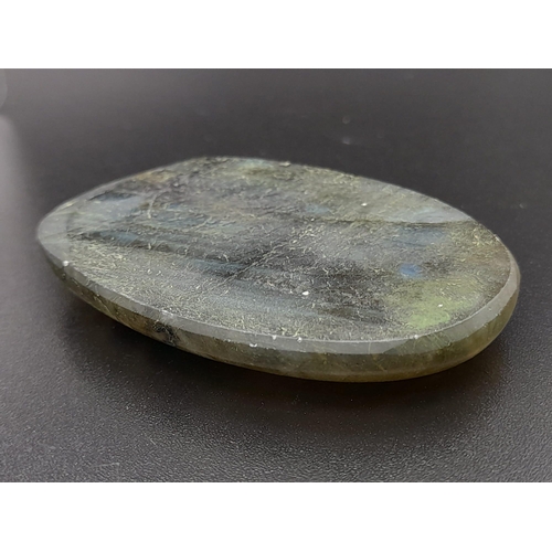 411 - An oval carved labradorite (113.95 carats) with GLA certificate. Dimensions: 49.70 x 32.86 x 8.28 mm... 