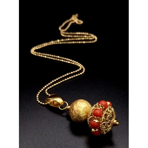 54 - An 18 K yellow gold pair of earrings with red coral and a matching pendant on 18 K chain. Pendant le... 