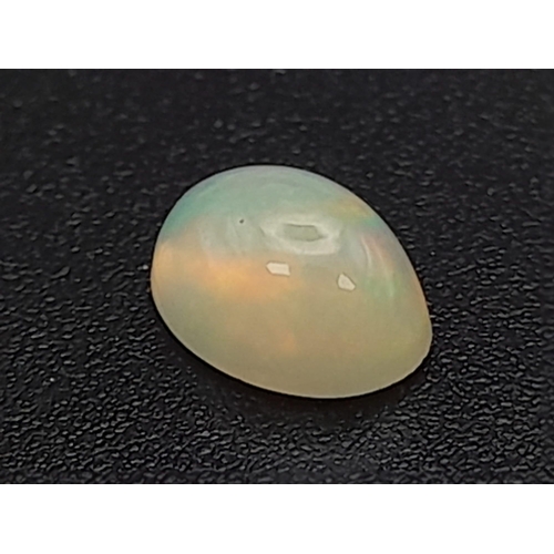 603 - A fire opal cabochon (0.65 carats) with GLA certificate. Dimensions: 6.84 x 5.20 x 3.50 mm. Original... 