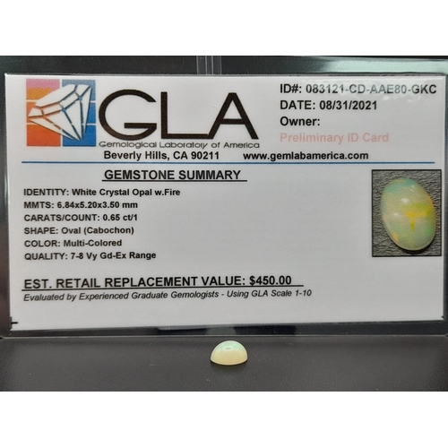 603 - A fire opal cabochon (0.65 carats) with GLA certificate. Dimensions: 6.84 x 5.20 x 3.50 mm. Original... 