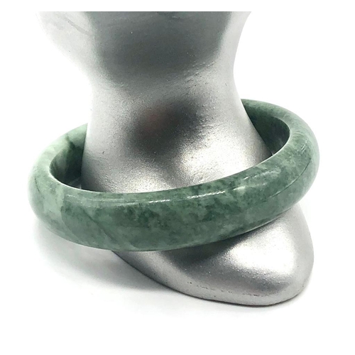 767 - A Green Jade Bangle. Inner diameter 6cm.