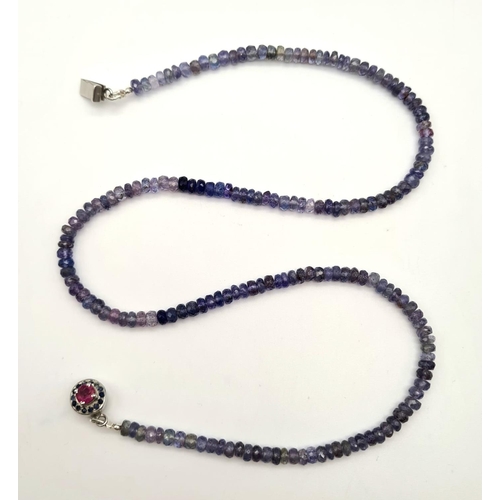 703 - Tanzanite Single Strand Necklace with Ruby Clasp in 925 Silver. 20.4 grams. Length: 48cm. Please see... 