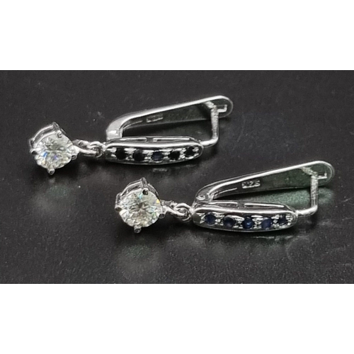 999 - 2ct White Moissanite Dangler Earrings with Blue sapphire Accents, 925 Silver. 3.5cm length