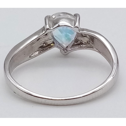 621 - A 9K Gold Topaz and Diamond Ring. Teardrop central topaz with smaller diamonds on shoulders. Size M ... 