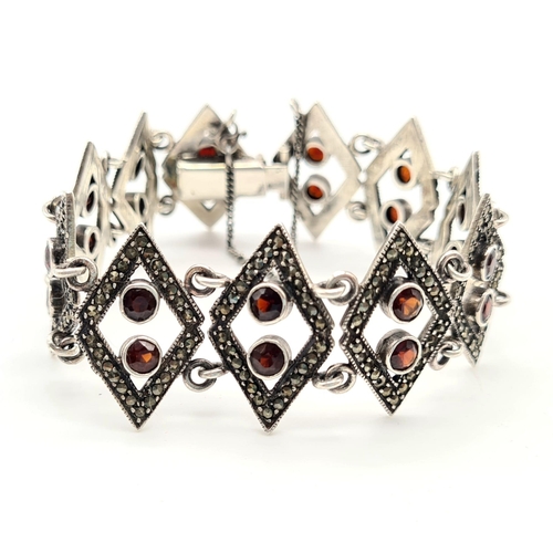 759 - STERLING SILVER FANCY GARNET SET BRACELET. 27G.
16CM