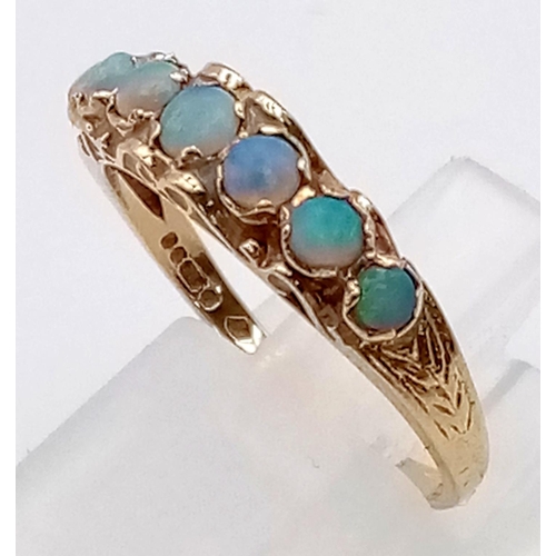 327 - An Antique 9K Yellow Gold Opal Ring. Seven graduating opal gemstones. Size M. 1.94g total weight.