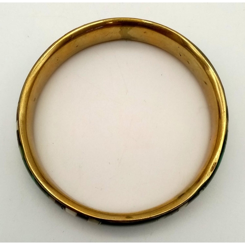 670 - A Vintage Malachite Bangle with Gilded Interior. 7cm inner diameter.