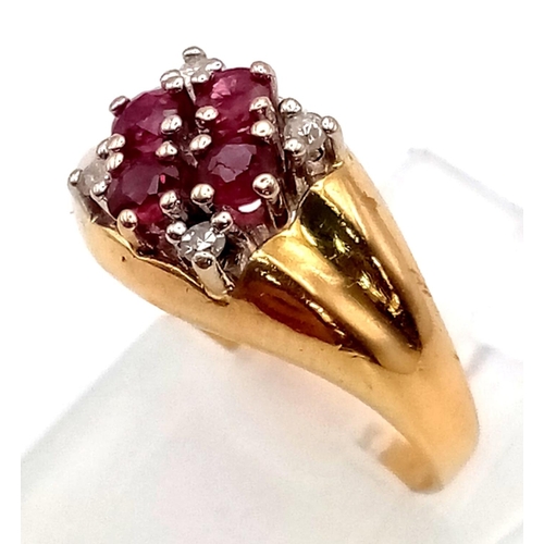 552 - An 18K Ruby and Diamond Ring. Four rubies and diamonds in a floral design. Size K. 3.47g.