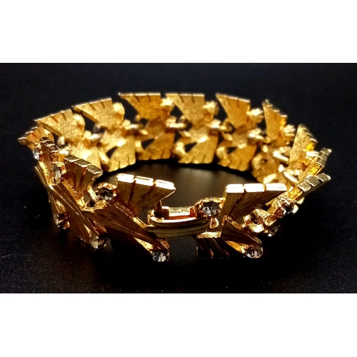 585 - A Richly Gilded Metal and White Stone Bracelet. Wonderful geometric pattern. 18cm