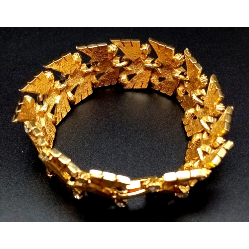 585 - A Richly Gilded Metal and White Stone Bracelet. Wonderful geometric pattern. 18cm