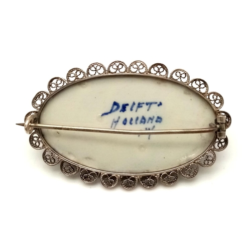 571 - An Antique Delft Ceramic Blue and White Brooch set in Silver. 5cm.