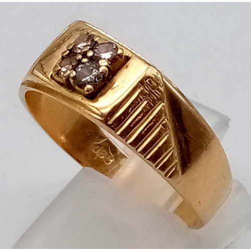 230 - An 18K Yellow Gold and Diamond Ring. Four square cut central diamonds. Size W. 6.79g total weight. R... 