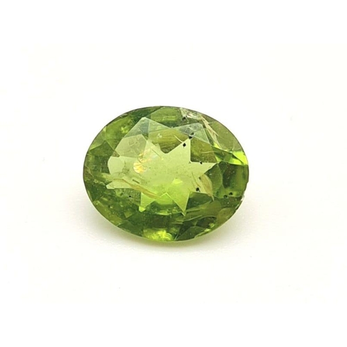 589 - An oval cut peridot (3.15 carats) with GLA certificate. Dimensions:10.60 x 8.71 x 4.62 mm. Original ... 