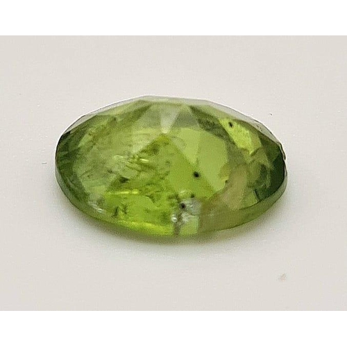 589 - An oval cut peridot (3.15 carats) with GLA certificate. Dimensions:10.60 x 8.71 x 4.62 mm. Original ... 