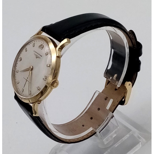 73 - An Exquisite 1960s Longines 14K Gold Gents Watch. Black leather strap with 14K gold case - 33mm. Whi... 