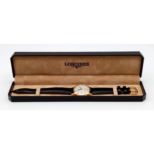 73 - An Exquisite 1960s Longines 14K Gold Gents Watch. Black leather strap with 14K gold case - 33mm. Whi... 