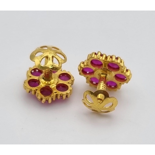 109 - A Mixed Gold Lot: A pair of 22k yellow gold earrings with red stones - 3.2g, a 22k yellow gold two b... 