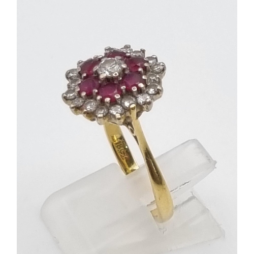 340 - An 18K Yellow Gold Ruby and Diamond Ring. Central diamond with ruby and diamond halos. Size P. 5.28g... 