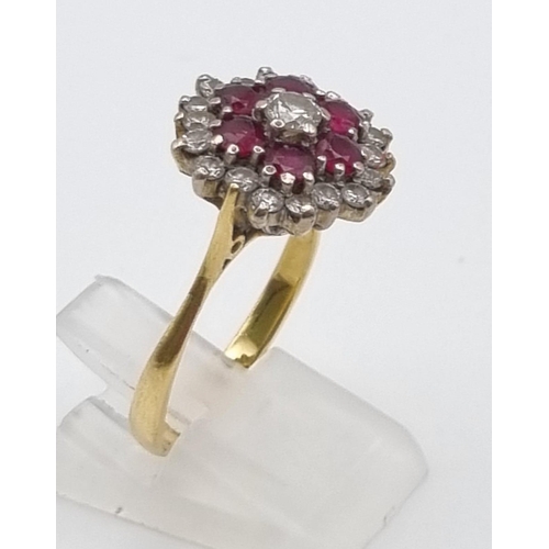 340 - An 18K Yellow Gold Ruby and Diamond Ring. Central diamond with ruby and diamond halos. Size P. 5.28g... 