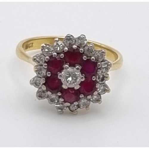 340 - An 18K Yellow Gold Ruby and Diamond Ring. Central diamond with ruby and diamond halos. Size P. 5.28g... 