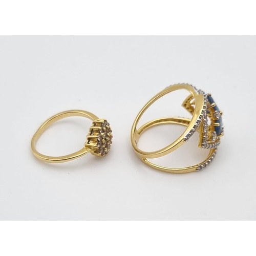 445 - Two 18K Yellow Gold Diamond Rings: A Crossover blue stones and diamond ring - size N and a floral sh... 