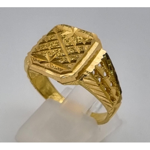 46 - A 22K Yellow Gold Signet Ring. Pierced and engraved decoration. Size V. 9.1g. Ref - 9212. Ring sligh... 