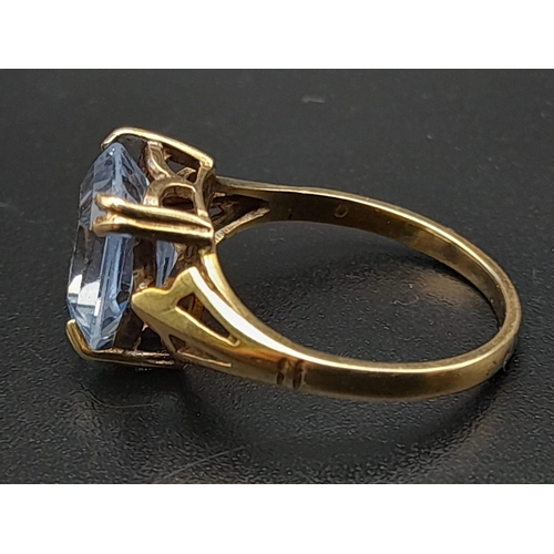 642 - A 9K Yellow Gold Blue Topaz Ring. Size J. 2.15g.