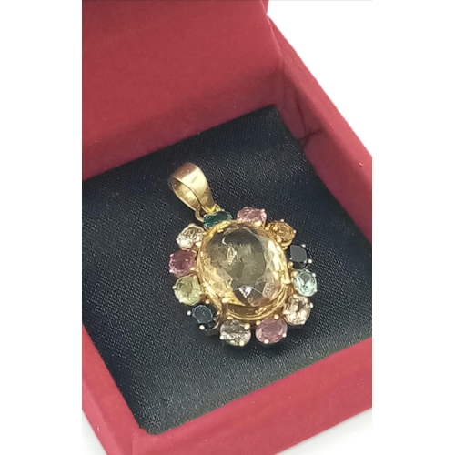 125 - A gold plated sterling silver pendant with a central oval cut citrine surrounded by a halo of round ... 