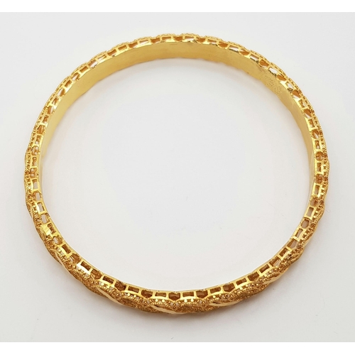 199 - A 21K Yellow Gold Asian Wedding Bangle. Pierced and filigree decoration. 6.5cm inner diameter. 13.44... 