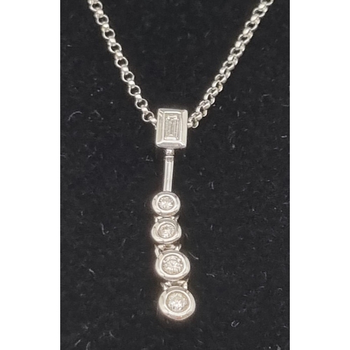 103 - An 18K White Gold Floating Graduated Diamond Pendant on an 18K White Gold Chain. 0.40ct of natural d... 