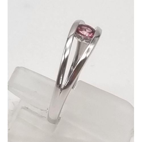 16 - An 18K White Gold 0.20ct Torsion Set Pink Tourmaline Ring. Elegant and very modern, this solitaire r... 