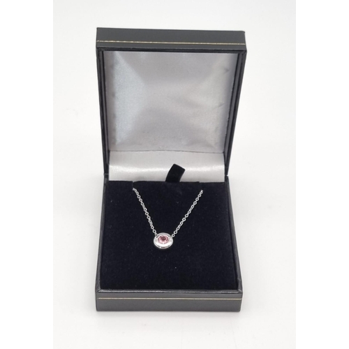 22 - A Floating Pink Tourmaline 18K White Gold Pendant on an 18K white gold chain. 0.55ct tourmaline. Pen... 