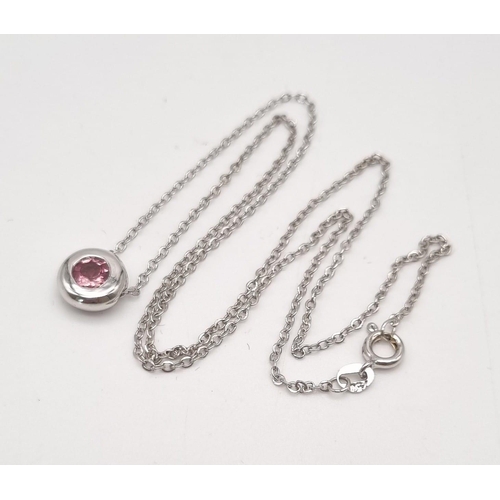 22 - A Floating Pink Tourmaline 18K White Gold Pendant on an 18K white gold chain. 0.55ct tourmaline. Pen... 