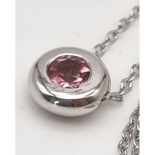 22 - A Floating Pink Tourmaline 18K White Gold Pendant on an 18K white gold chain. 0.55ct tourmaline. Pen... 