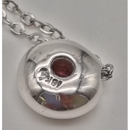 22 - A Floating Pink Tourmaline 18K White Gold Pendant on an 18K white gold chain. 0.55ct tourmaline. Pen... 