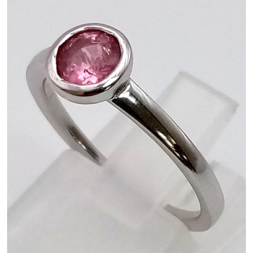 89 - An 18K White Gold Pink Tourmaline Rub-over Ring. A beautiful pink tourmaline set in a rub-over setti... 