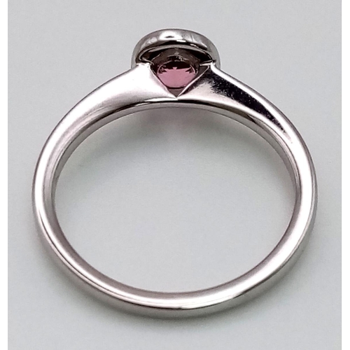 89 - An 18K White Gold Pink Tourmaline Rub-over Ring. A beautiful pink tourmaline set in a rub-over setti... 