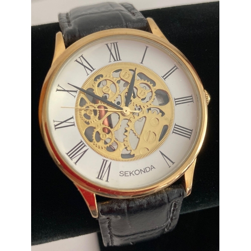 120 - Gentlemans quartz SEKONDA SKELETON WRISTWATCH in gold tone,, having large face with black digits and... 