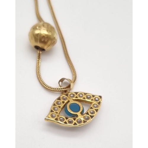 179 - A 21K Yellow Gold Blue-Eye Pendant and Necklace with a 21K Yellow Gold Pair of pierced and filigree ... 