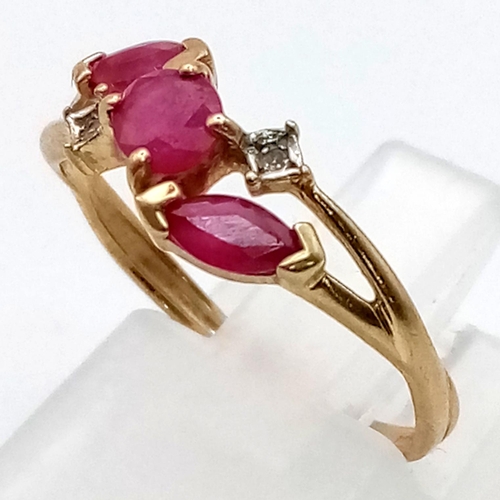 354 - A 9K Yellow Gold Ruby and Diamond Crossover Ring. 
Size L. 1.3g total weight.