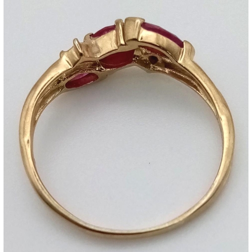 354 - A 9K Yellow Gold Ruby and Diamond Crossover Ring. 
Size L. 1.3g total weight.