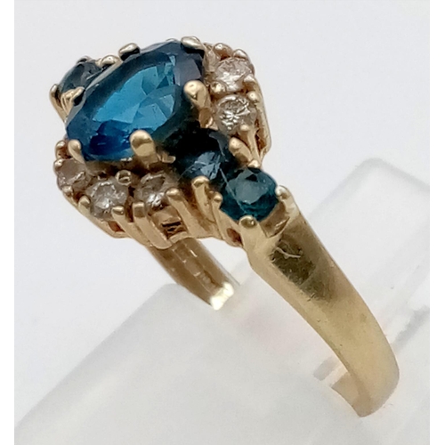 407 - A 9K Yellow Gold Blue and White Stone Dress Ring. Size M. 3.1g total weight.