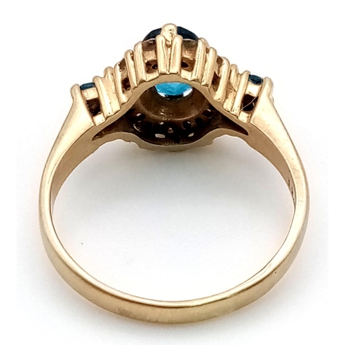 407 - A 9K Yellow Gold Blue and White Stone Dress Ring. Size M. 3.1g total weight.