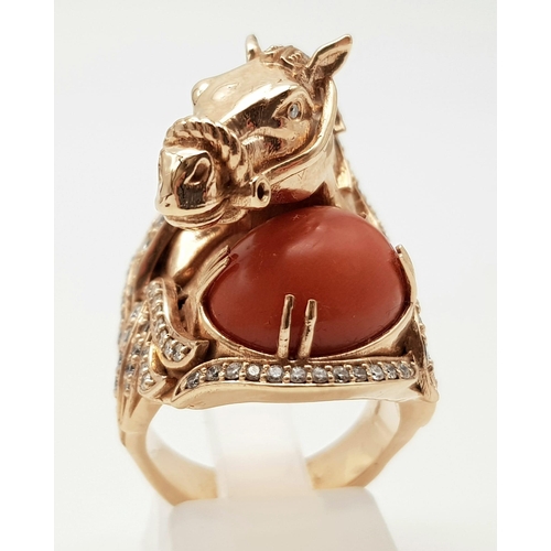 507 - An 18K Yellow Gold Natural Coral & Diamond Horse Figure Ring. 25.36g total weight. Size L 1/2.