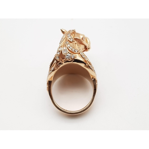 507 - An 18K Yellow Gold Natural Coral & Diamond Horse Figure Ring. 25.36g total weight. Size L 1/2.