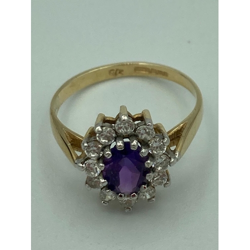 372 - 9 carat yellow GOLD RING having Amethyst centre with clear zirconia surround.
 2.1 grams. Size M.