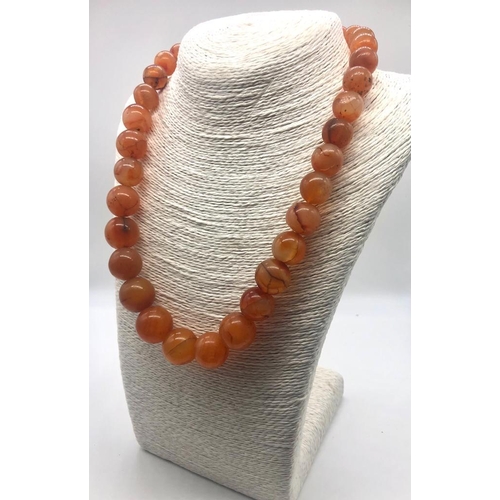 187 - An Autumn Fire Graduated Onyx Bead Necklace. Largest bead 20mm. 46cm necklace length.